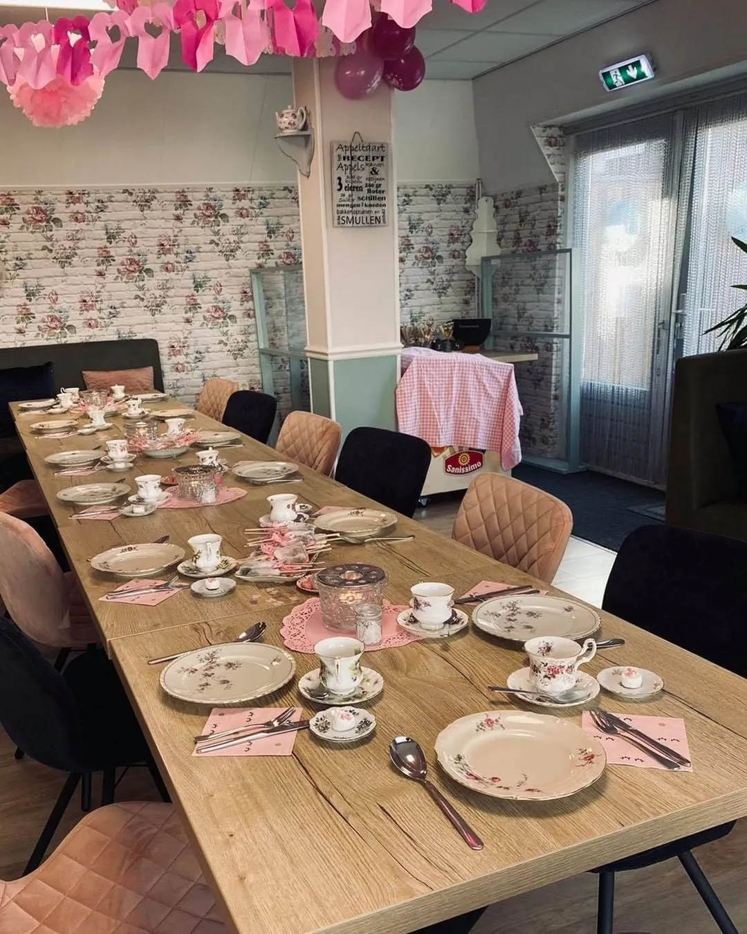 Een lange, feestelijk gedekte tafel in het teehûs.
